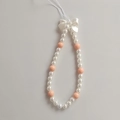 Detail of beaded phone strap with pink beads, white pearls, and a 3D bow accent - Pearl Style Bow Phone Chain