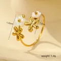 Detail view of 18K gold plated ring with white shell flower charms and 1.4g weight - One Size (Adjustable Open) / Four Flowers Rural Style (Two White Two Gold)