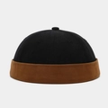 Detail of two-tone docker cap featuring black crown and brown brim in cotton twill fabric - Black With Caramel Edge