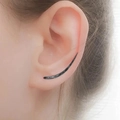 Minimalist black curved ear crawler earring shown on a model with elegant close-up detail - Black & Gold