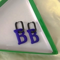 Klein blue letter B earrings with gunmetal square hoops on yellow satin fabric - Klein Blue Letter B Matte Hoop Earrings