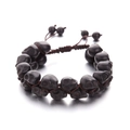Macro detail of hand-woven turquoise skull bracelet with polished black stone beads - Double Layer Black Skull