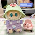 Labubu doll in green corduroy hat and purple overalls sitting on a tiny pink chair - Purple Pocket Straps + Red Heart And Green Hat / First And Second Generation Keychains Are Compatible With La Cloth Dolls. Dolls Not Included.