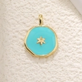 Macro shot of irregular sky blue enamel pendant with a golden star on white texture - Star