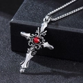 Macro shot of Gothic silver cross necklace with a central red gemstone and metal chain - Silver Red Gem Cross (XL427)