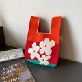 Knitted tote bag with vibrant orange, red, and blue blocks featuring white floral patterns - Xmas Red Three Flowers