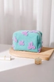 Dettaglio della trousse in peluche verde menta con fiocco viola e trama vellutata - Verde Menta Borsa a Cuscino