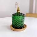 Green glass storage jar with diamond texture and gold lid on wooden tray - Green Gold