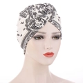 Detail of bohemian paisley print turban with a stylish knot on a white mannequin - White Paisley