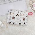 Close-up of white quilted cosmetic bag featuring cute cartoon dog prints and a pink ring hook - Cartoon Dog