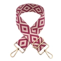 Macro view of geometric jacquard wide bag strap with golden hardware and pink diamond pattern - Beige and Purple Red