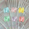 Macro shot of colorful mini resin letters M and W on a rainbow crystal plate - Letter N