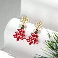 Detailansicht der Weihnachtsbaum-Ohrringe mit goldener Schneeflocke und rotem Baum - Rot