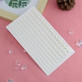 Face gem sticker sheet with multiple sized off-white half pearls on pink backdrop - Linked Faux Pearl Stickers