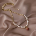 Detail of baroque pearl necklace with gold beads and a red flower bud pendant on silk - Flower Pendant Style (5#16701D)