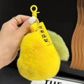 Cute yellow plush pear keychain with green leaf detail and motivational yellow tag - Yellow Pear No Pressure