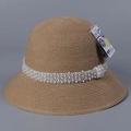 Detail of beige straw sun hat showing pearl bead trim and UPF 50+ UV protection tag - M(56-58cm) / Khaki