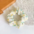Close-up of white fabric hair scrunchie with yellow lemon pattern on lace and wood - Yellow Cherry Large