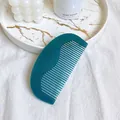 Dark green acetate wide tooth comb with brand logo on elegant white marble tray - Comb-Green