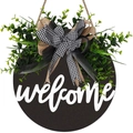 Wooden welcome door sign with greenery and checkered burlap bow on black background - WELCOME / Black