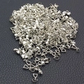 Silver metal pendant clasps for jewelry making displayed on a black textured surface - Silver Pinch Bails 14mm (10pcs)