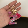 Detail of resin letter Z keychain with pink sequins, shell flakes and pompom ball - Small Ball Tassel Clasp / Letter Z