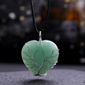Macro detail of wire-wrapped tree of life heart pendant with green crystal stone - Green Aventurine