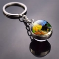 Detailed shot of Cafe Terrace at Night oil painting on a glass dome metal keychain - Café Terrace at Night