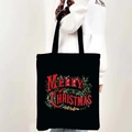 Detail of black canvas Christmas tote bag with Merry Christmas text shown on model - Style 05-Merry Christmas Red Letter