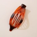 Flat oval hair claw clip in amber tortoise shell resin with strong grip for styling - Glossy Striped Amber