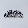 Detail of a portable mini black and white marble acetate hair comb with wide teeth - Black & White