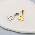 Gold and silver wing-shaped heart pendants with lobster clasps on a textured tray - Little Angel