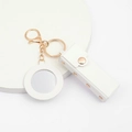 White faux leather lipstick pouch with gold hardware, mirror charm, and snap closure - White