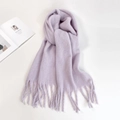 Detailed close-up of soft lavender knitted scarf with decorative long fringe tassels - Light Purple
