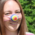 Handmade crochet breast-shaped nose warmer with colorful yarn for fun winter warmth - Universal Tied Size / Anatomical Rainbow Style