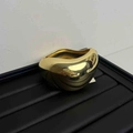 Minimalist golden heart metal ring with high polish finish on a black display tray - Gold