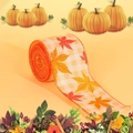 Detail of autumn harvest ribbon featuring maple leaves on orange and white plaid - Maple Leaf