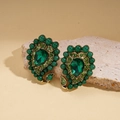 Close-up of vintage emerald green waterdrop earrings with crystals on a stone base - Waterdrop Green Earrings
