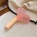 Detail of pink acrylic heart hair clip with white stitching and textured beige handle - Deep Pink