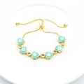 Detail of adjustable gold bracelet with blue heart evil eye charms and zircons - Light Blue