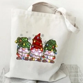 Detail of Christmas gnomes print on a cream canvas tote bag with festive holiday patterns - White