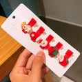 Detail shot of five Christmas hair clips featuring snowman, Santa, and holiday motifs - 5-Piece Christmas Hair Clip Collection