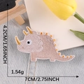 Cute cartoon triceratops dinosaur embroidery patch with gold thread details on fabric - Light Brown Triceratops