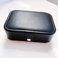 Portable black PU leather jewelry box with textured finish and silver metal snap closure - 16*11*5cm / Black