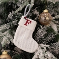 White knitted Christmas stocking with red embroidered letter F hanging on a tree - Embroidered Knitted Small Sock White F