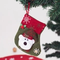 Christmas stocking with white bear ornament and snowflake hat hanging on a tree - Bear