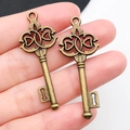 Two vintage bronze alloy key pendants with heart details for creative DIY jewelry making - Antique Bronze Key 16x45mm