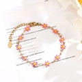 Detail of gold stainless steel chain bracelet with pink enamel daisy flower charms - Pink