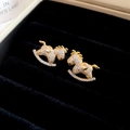 Macro shot of gold rocking horse earrings with micro-set white zircon on a black velvet box - Style 7 Pave Zircon Rocking Horse Earrings-Silver Needle (Gold)