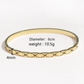 Detail view of a 4mm gold polished bangle with X-shaped engraving and 6cm diameter - Small Gold X-Cross Pattern (Small Gold)